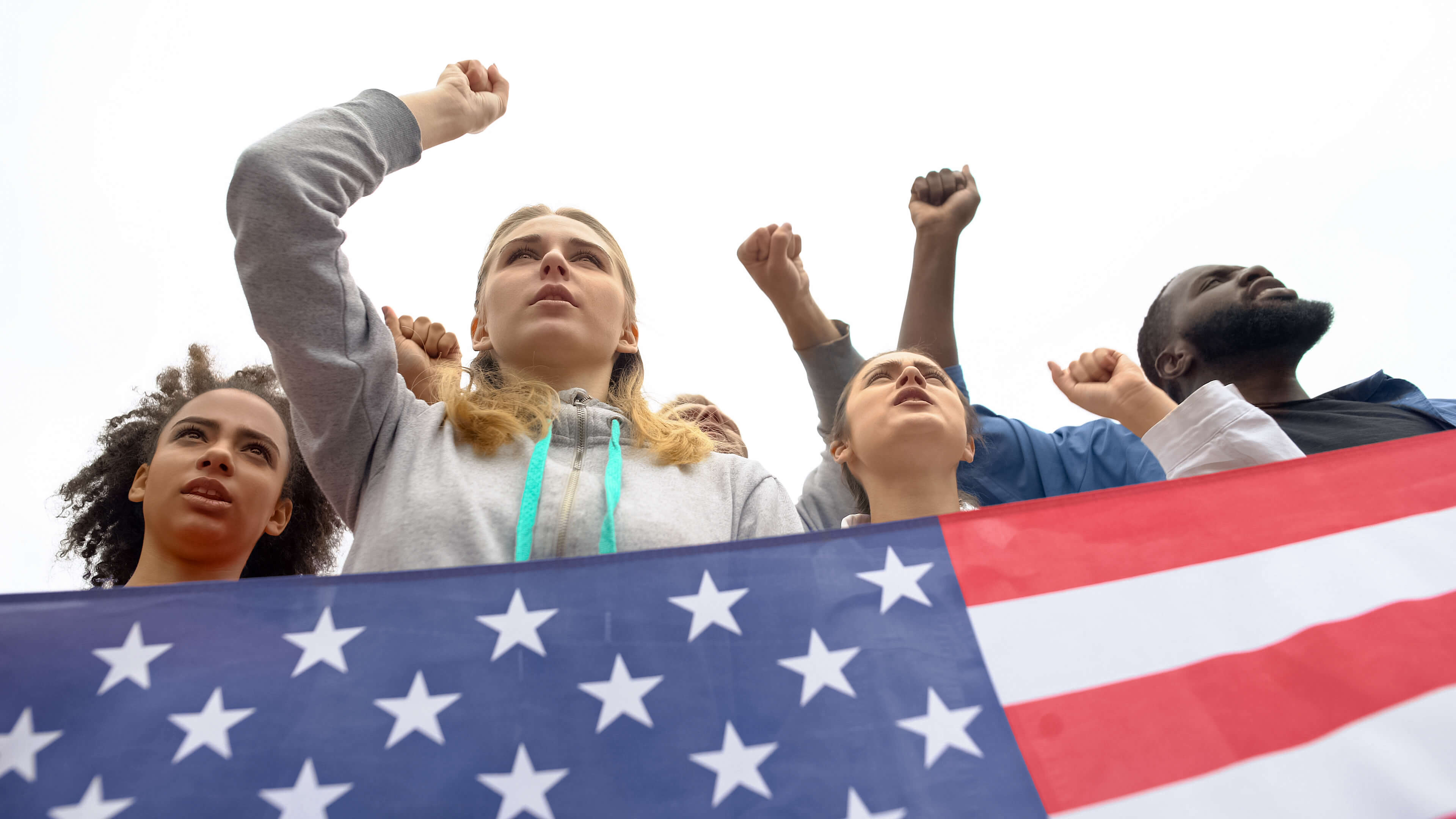 Photo of a group of young people holding the American flag.
