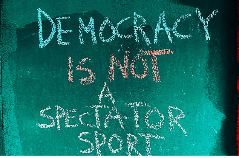Image stating Democracy is not a spectator sport.