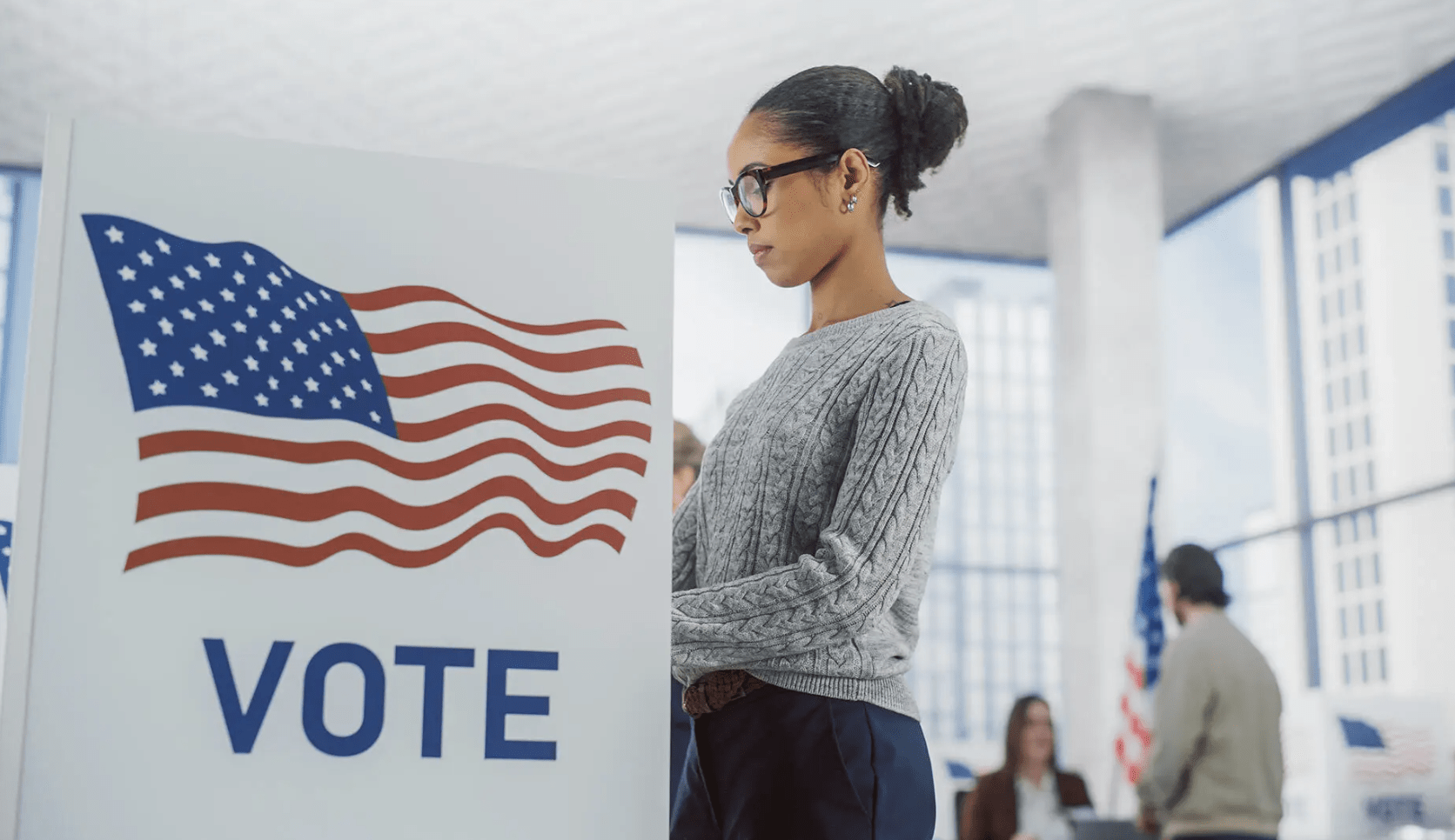 Istock photo of a female at the voting booth.